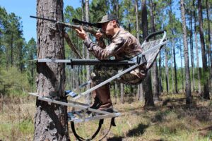 Gunslinger Tree Stand Holding Gun